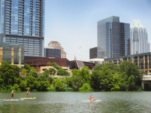 Austin City Hall with Stand Up Paddleboarders on Lady Bird Lake